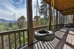 Tire swing on terrace level covered deck